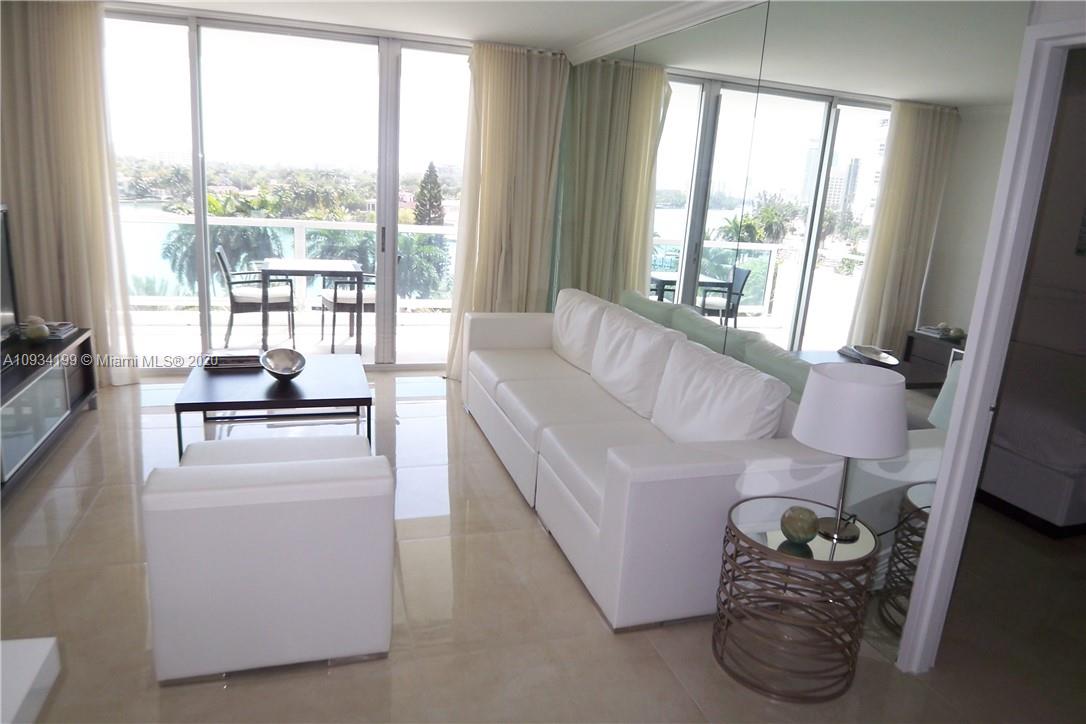 5161 Collins Avenue, Unit 806 Miami Beach, FL 33140 - Photo 3 of 52 a living room with furniture and a large window