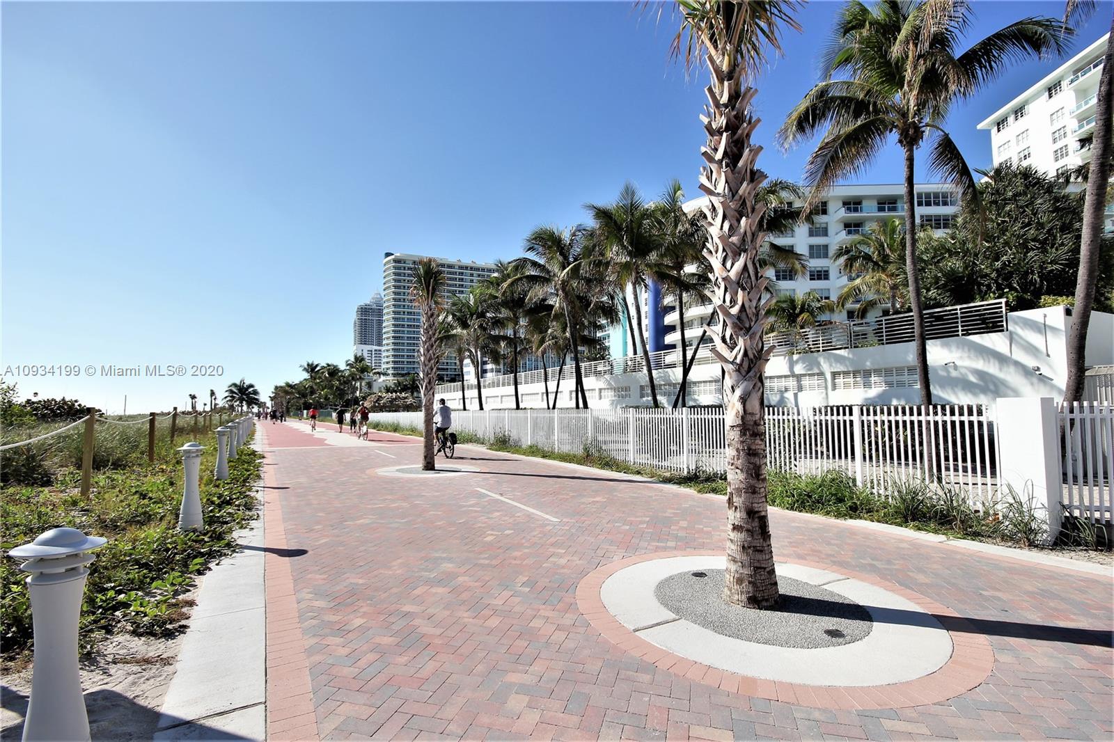 5161 Collins Avenue, Unit 806 Miami Beach, FL 33140 - Photo 38 of 52 a swimming pool with outdoor seating and yard