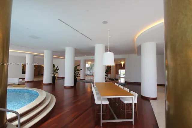 a living room with furniture a table and wooden floor