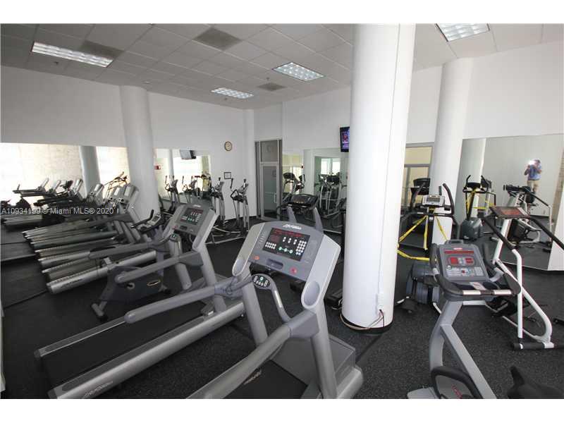 5161 Collins Avenue, Unit 806 Miami Beach, FL 33140 - Photo 47 of 52 a view of a room with gym equipment