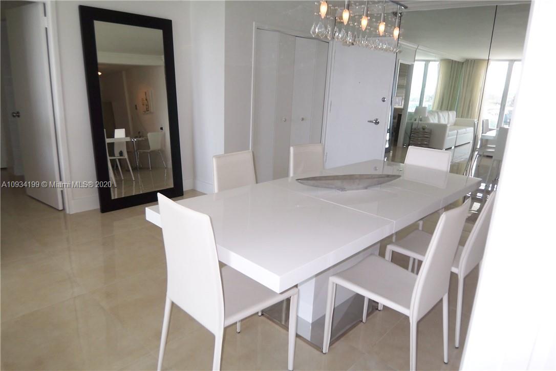 5161 Collins Avenue, Unit 806 Miami Beach, FL 33140 - Photo 8 of 52 a view of a dining room with furniture and wooden floor