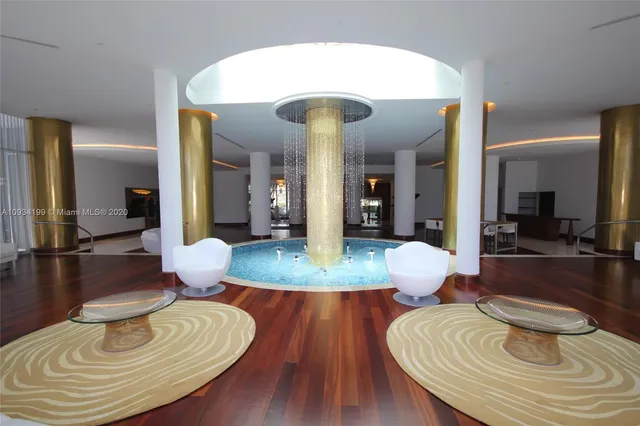 a living room with dining room and wooden floor