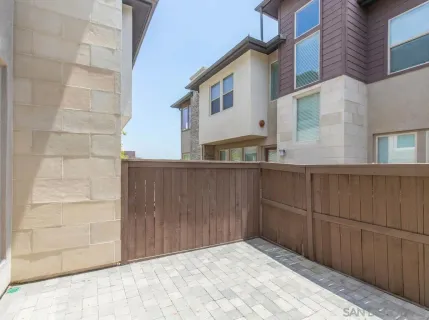 a view of a house with a wooden fence