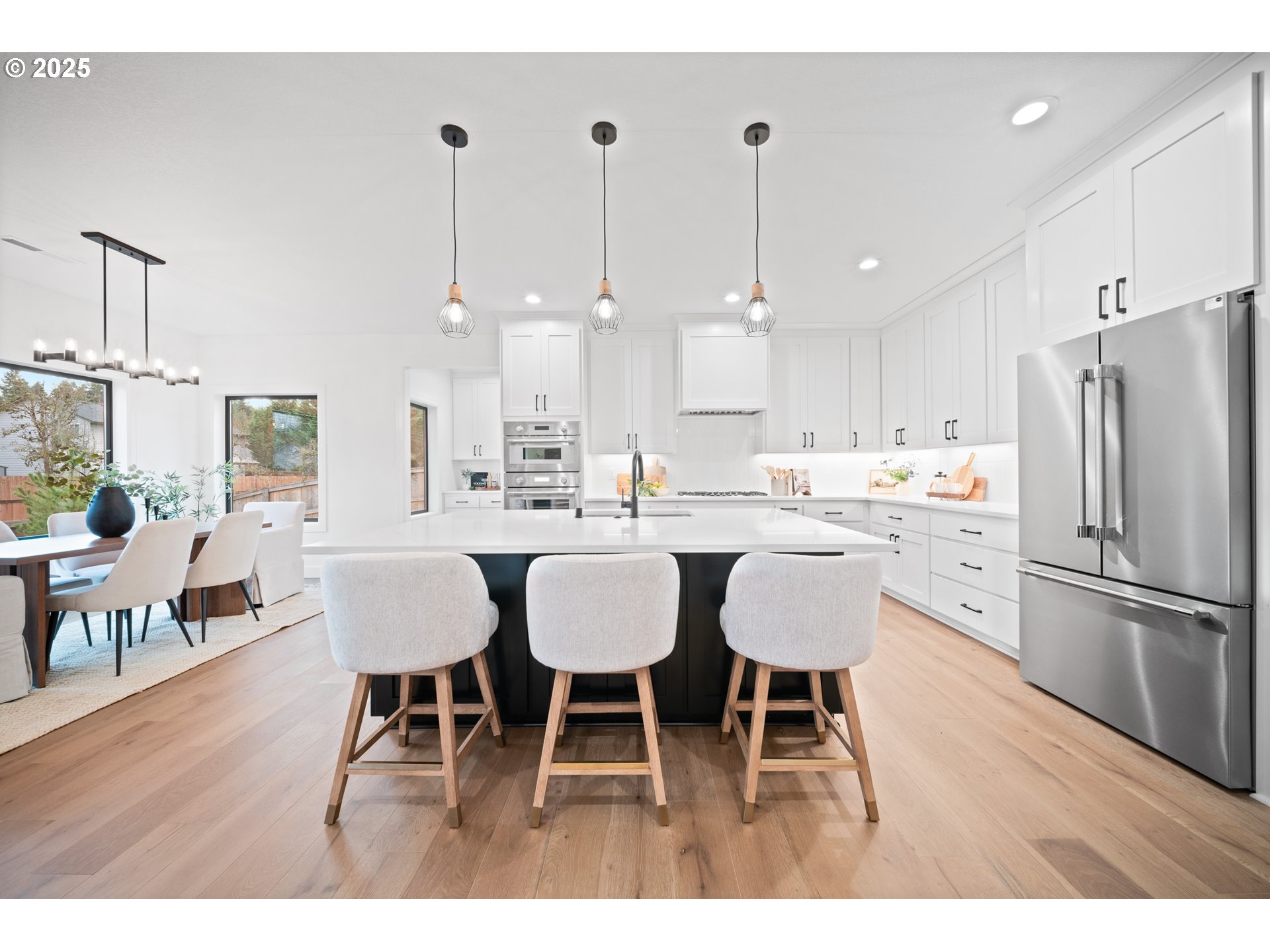 1211 Northwest 150th Street Vancouver, WA 98685 - Photo 9 of 23 a kitchen with stainless steel appliances kitchen island granite countertop a dining table chairs and sink