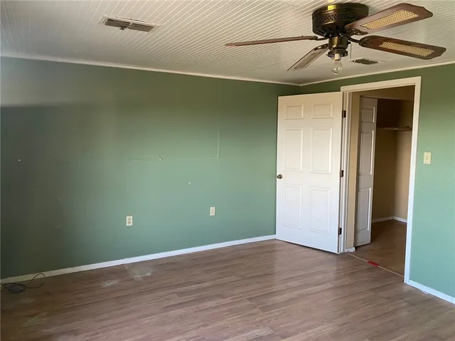a view of a chandelier fan and wooden floor