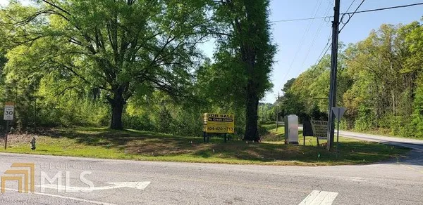 a view of a park that has large trees
