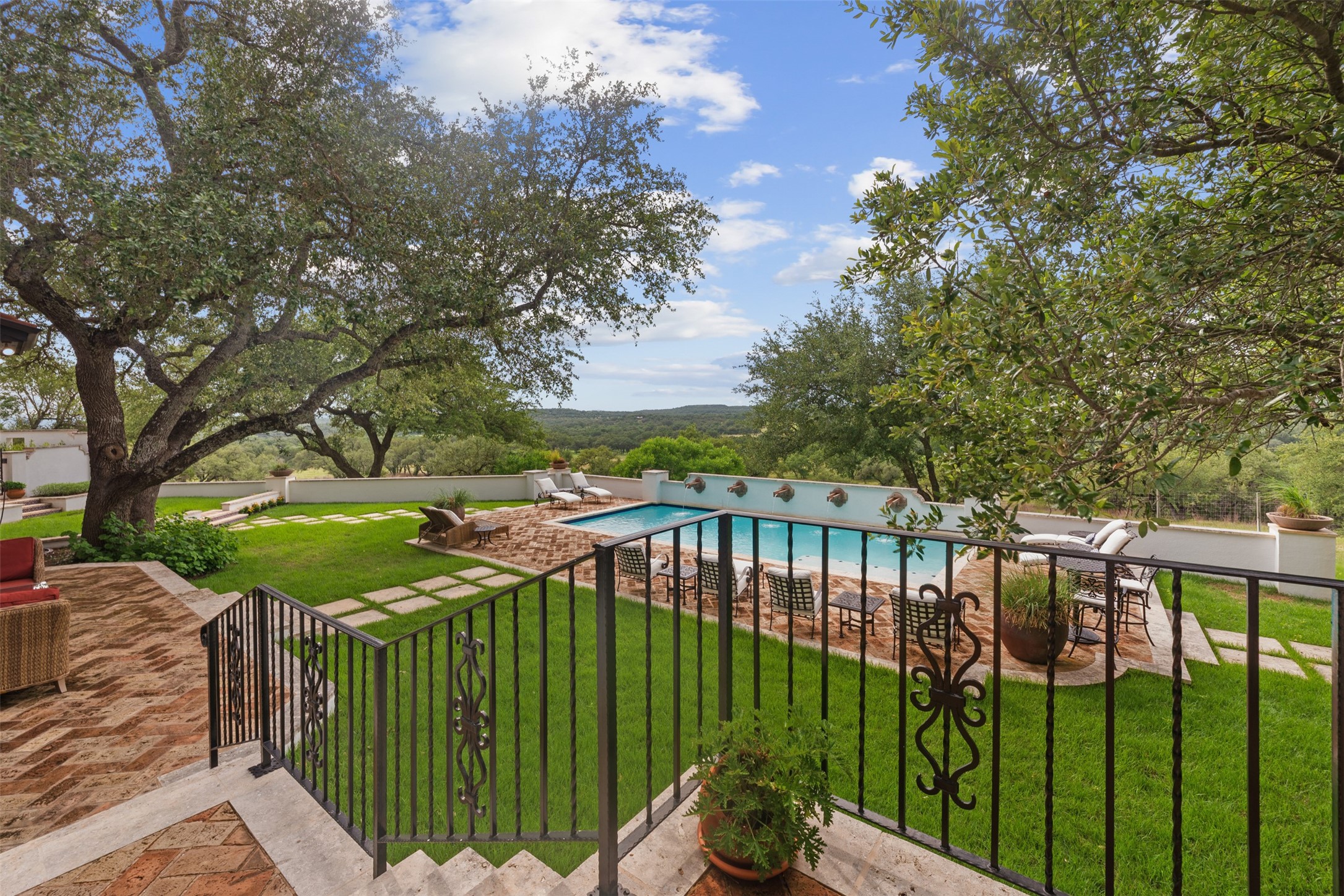 34000 Smithson Valley Road Bulverde, TX 78163 - Photo 29 of 50 The beautifully landscaped backyard is shaded by heritage live oaks and features a resort-style pool, greenhouse conservatory, and multiple outdoor gathering spaces. A true private oasis designed for relaxation and entertaining.