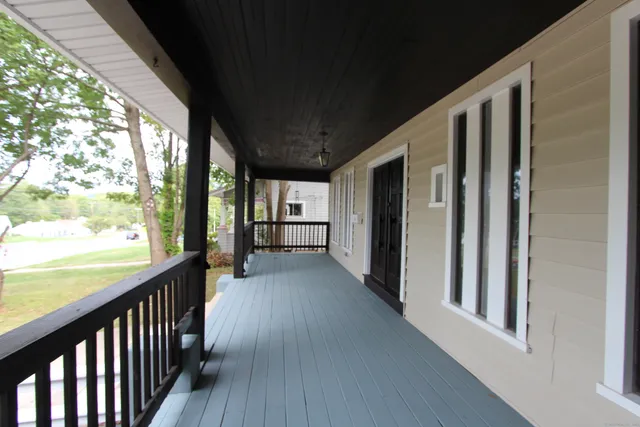 a view of a porch with wooden floor and outdoor space