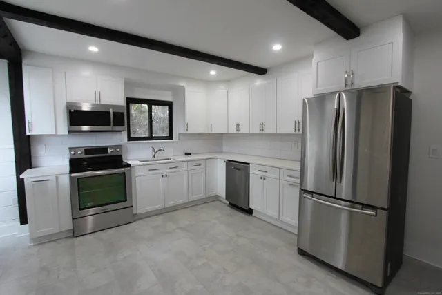 a kitchen with a refrigerator stove and microwave