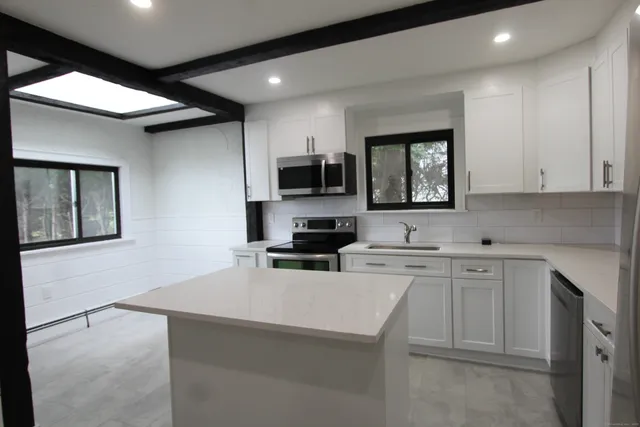 a kitchen with a sink cabinets and window