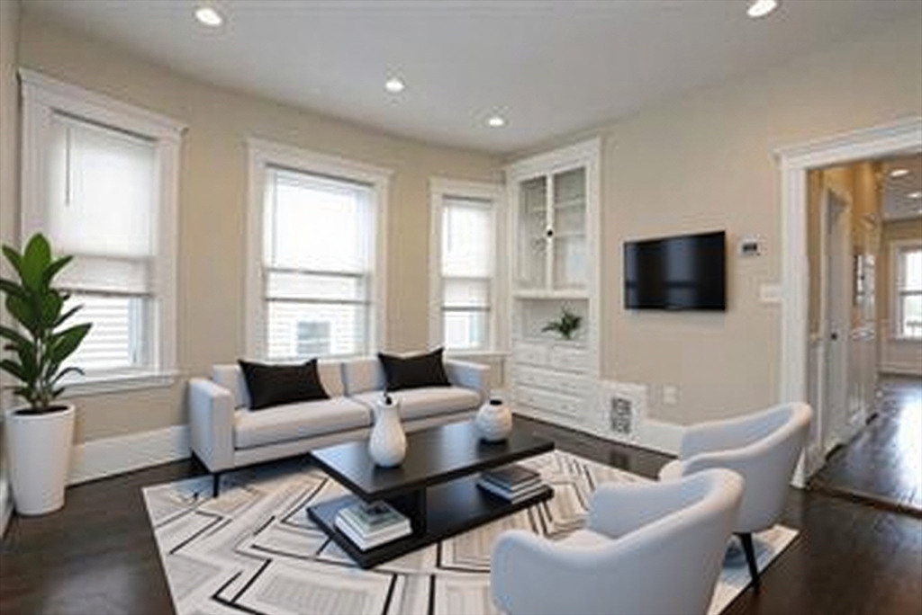 41 St Edward Road, Unit 3 Boston, MA 02128 - Photo 3 of 12 a living room with furniture and a flat screen tv