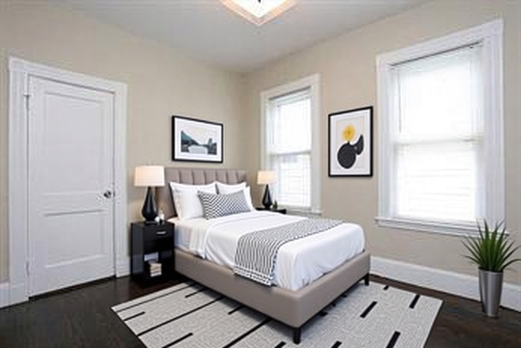 41 St Edward Road, Unit 3 Boston, MA 02128 - Photo 5 of 12 a bedroom with a bed painting on wall and a window