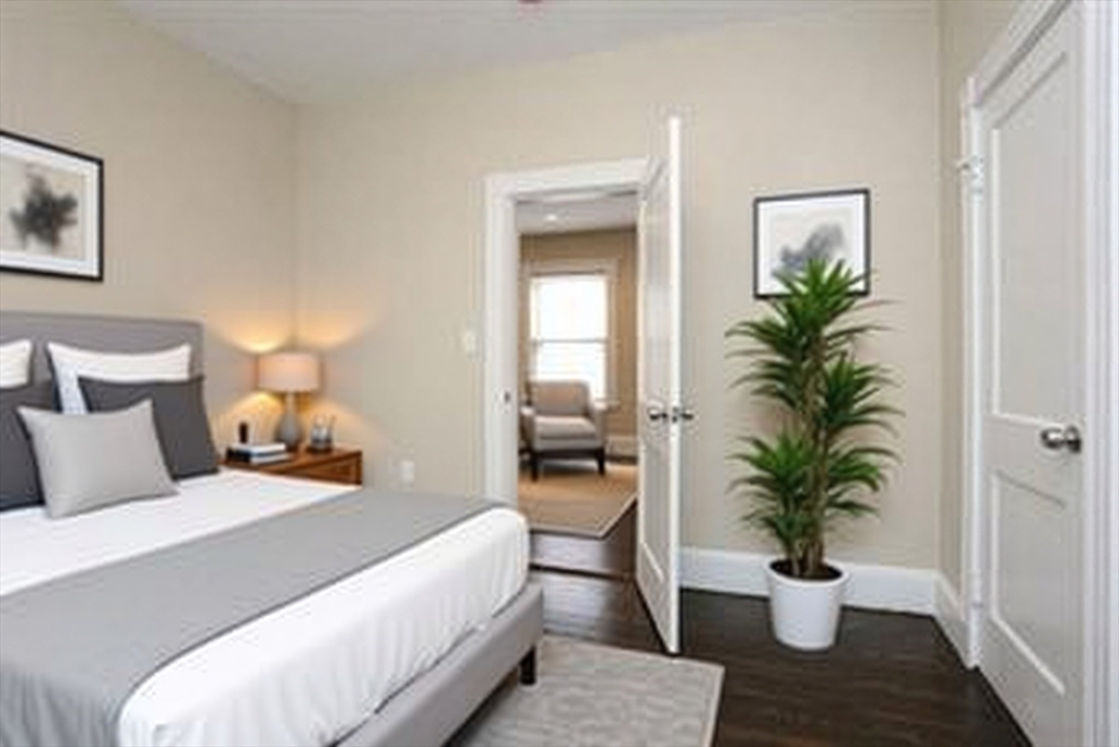 41 St Edward Road, Unit 3 Boston, MA 02128 - Photo 6 of 12 a bed room with a bed and a potted plant