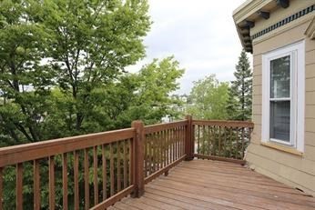 41 St Edward Road, Unit 3 Boston, MA 02128 - Photo 10 of 12 a balcony with wooden floor and fence