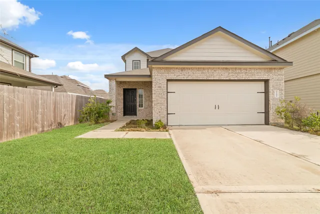 a view of a house with a yard and garage