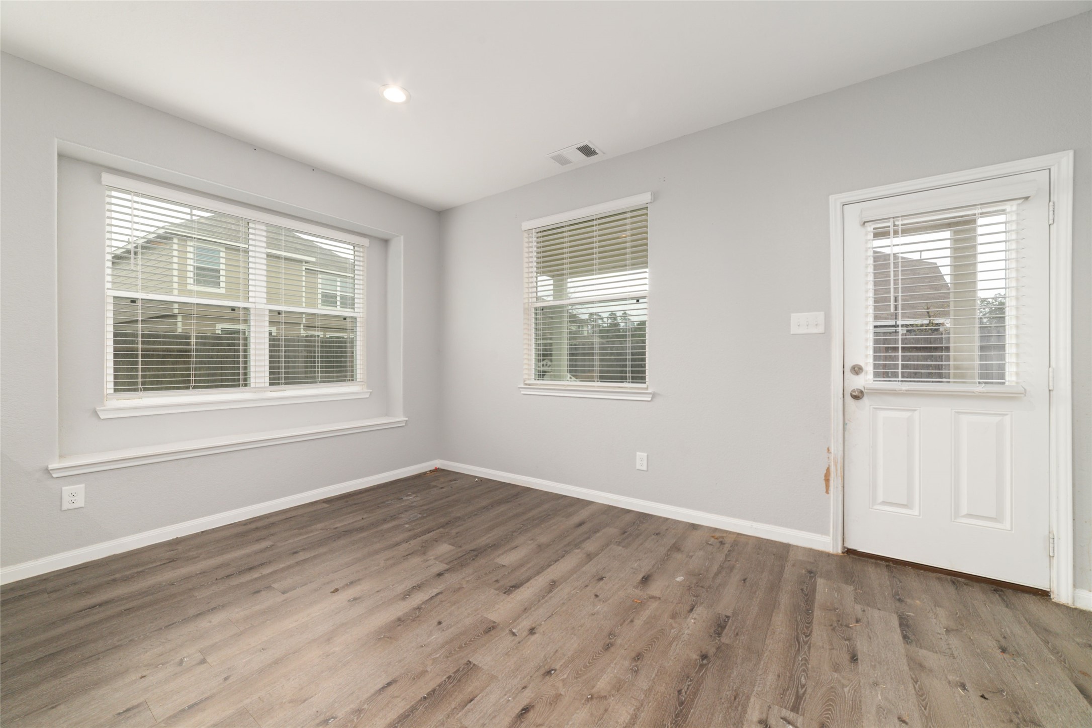 2209 Raider Drive Conroe, TX 77301 - Photo 11 of 27 a view of empty room with wooden floor and fan