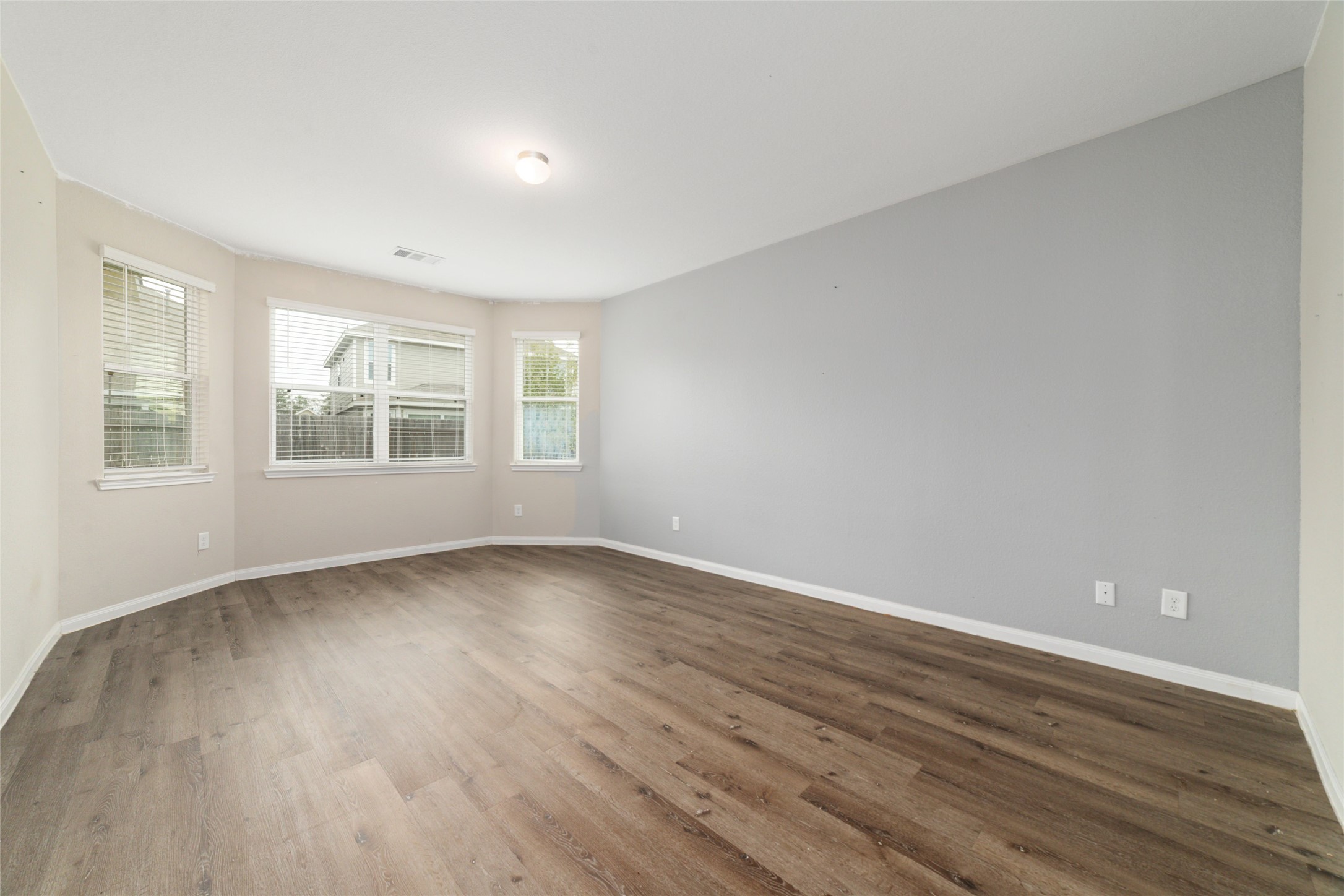 2209 Raider Drive Conroe, TX 77301 - Photo 14 of 27 a view of an empty room with wooden floor and a window