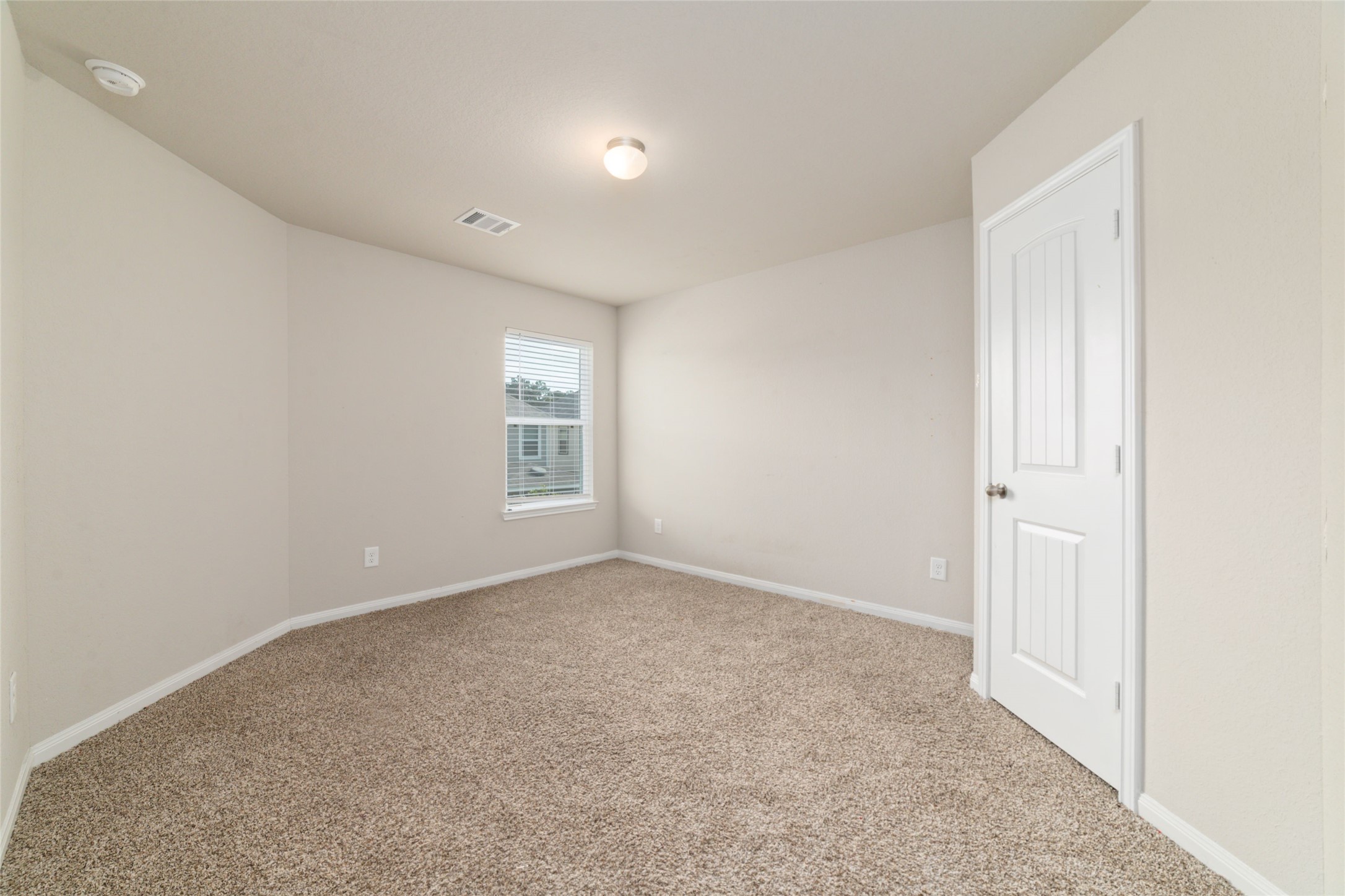 2209 Raider Drive Conroe, TX 77301 - Photo 22 of 27 an empty room with windows and closet