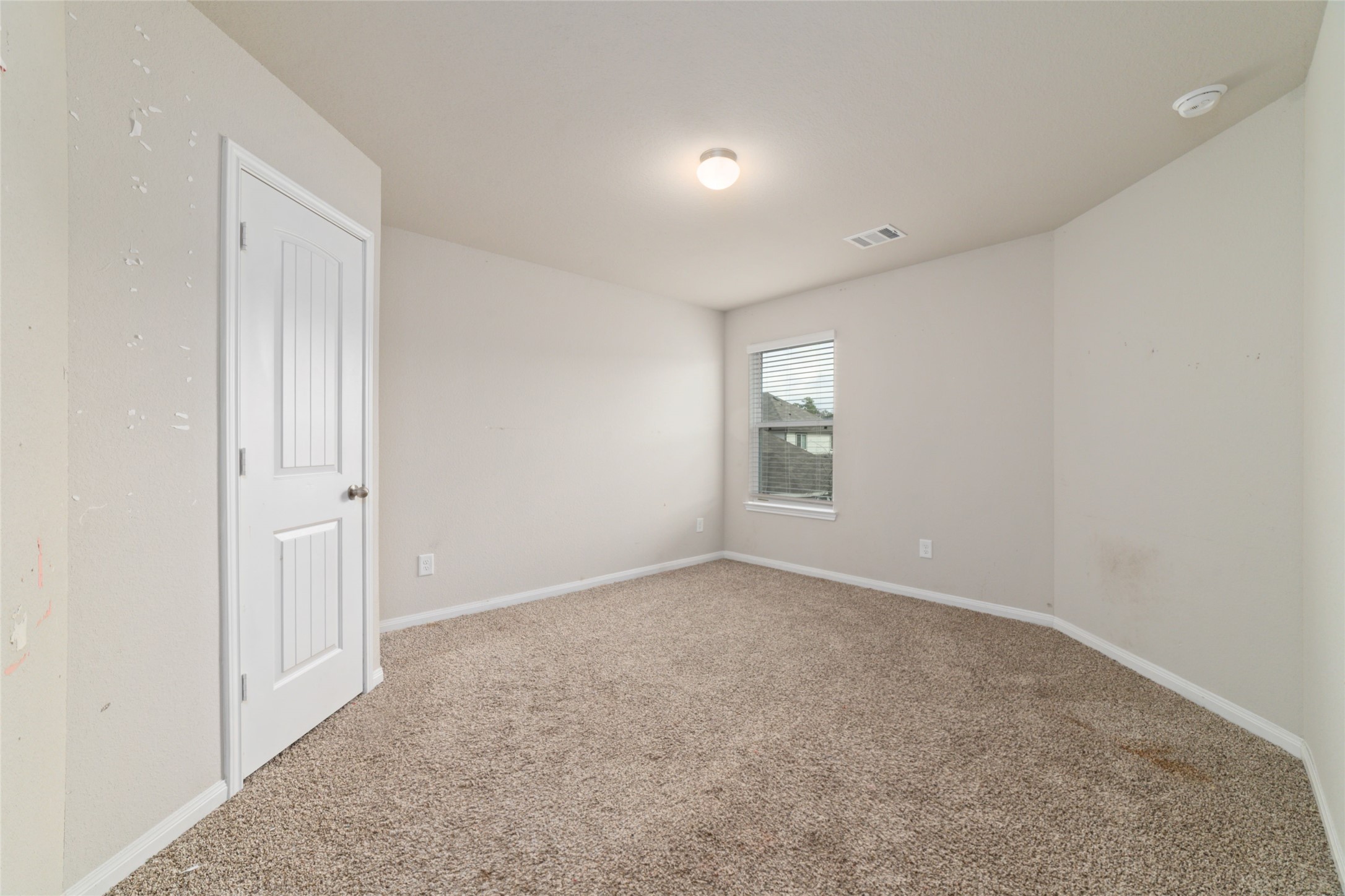 2209 Raider Drive Conroe, TX 77301 - Photo 24 of 27 an empty room with a empty space and windows
