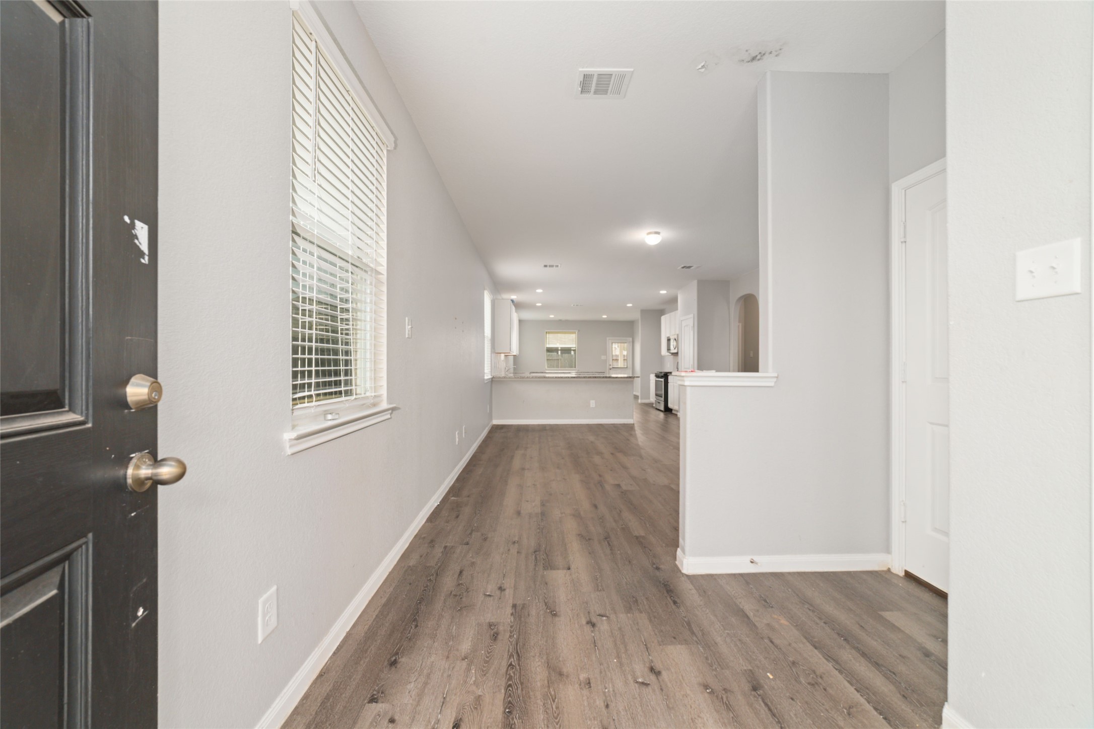 2209 Raider Drive Conroe, TX 77301 - Photo 3 of 27 a view of a kitchen from the hallway