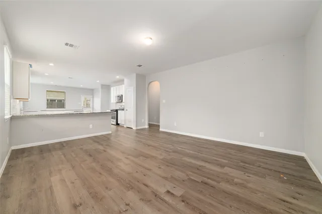 a view of a kitchen with wooden floor and a sink