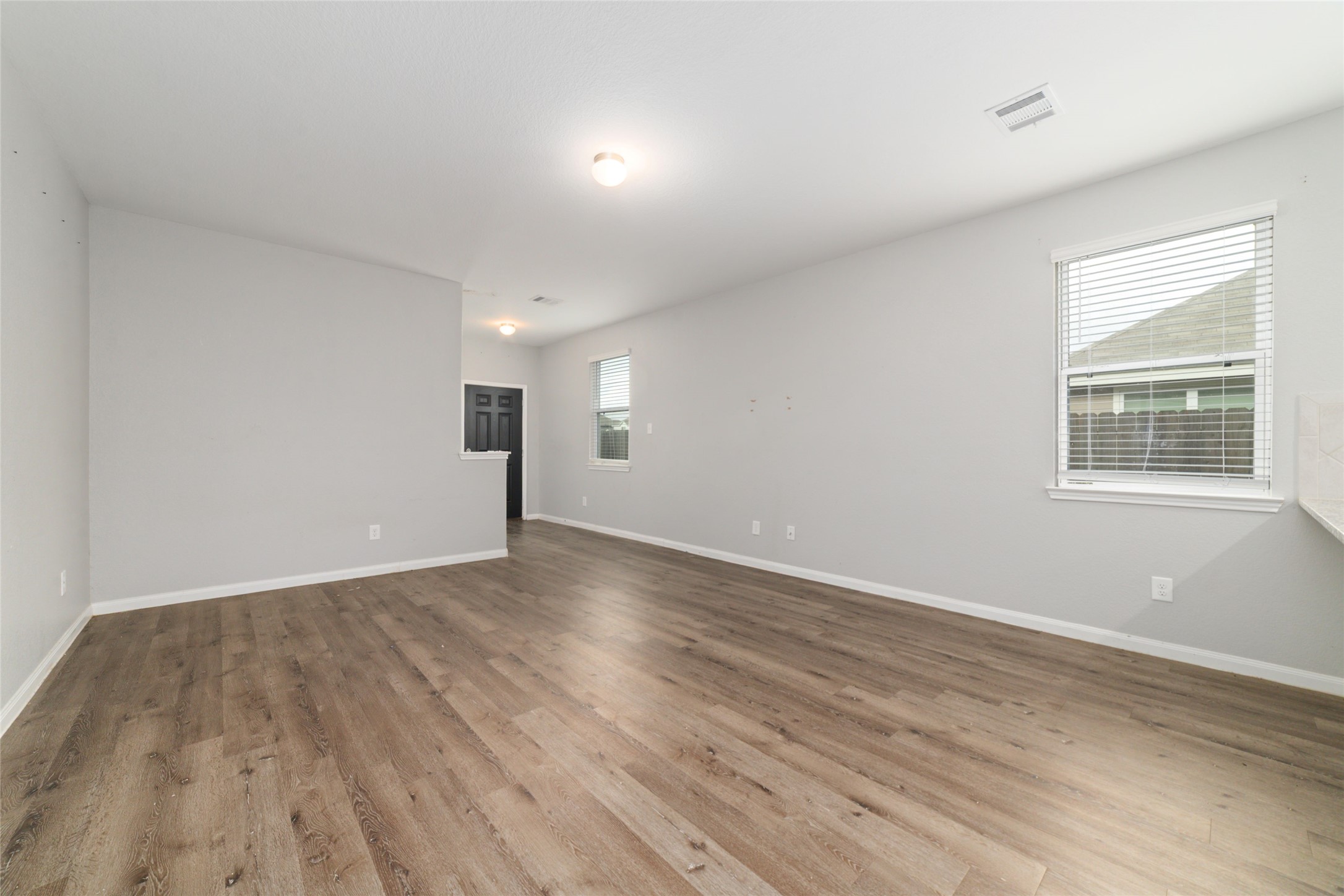 2209 Raider Drive Conroe, TX 77301 - Photo 6 of 27 a view of empty room with wooden floor and fan