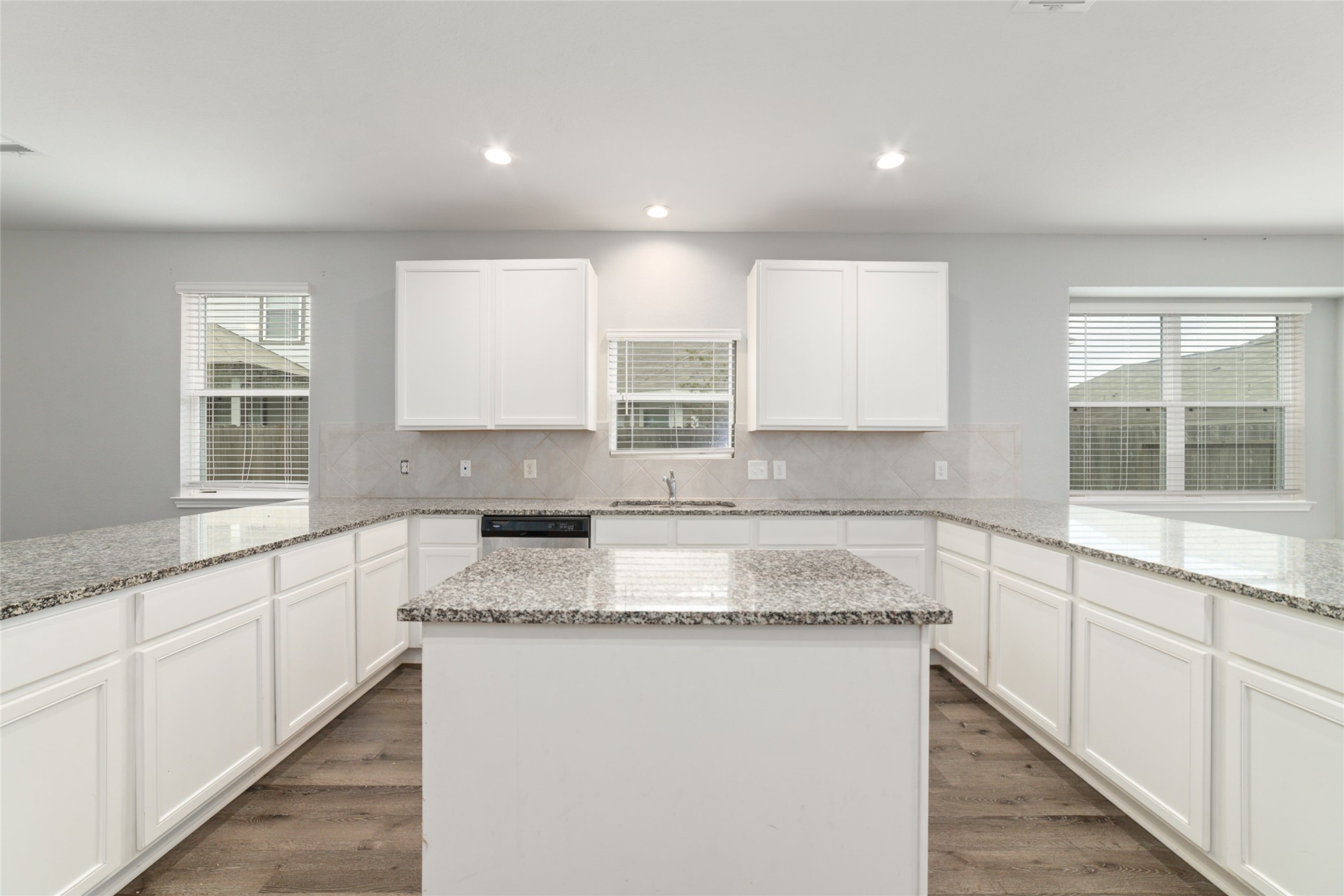 2209 Raider Drive Conroe, TX 77301 - Photo 8 of 27 a kitchen with granite countertop white cabinets and a window