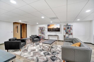 2016 Main Street, Unit 1116 Houston, TX 77002 - Photo 13 of 23 a living room with furniture and a flat screen tv