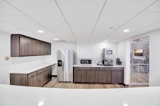 2016 Main Street, Unit 1116 Houston, TX 77002 - Photo 17 of 23 a kitchen with stainless steel appliances kitchen island granite countertop a refrigerator and a sink