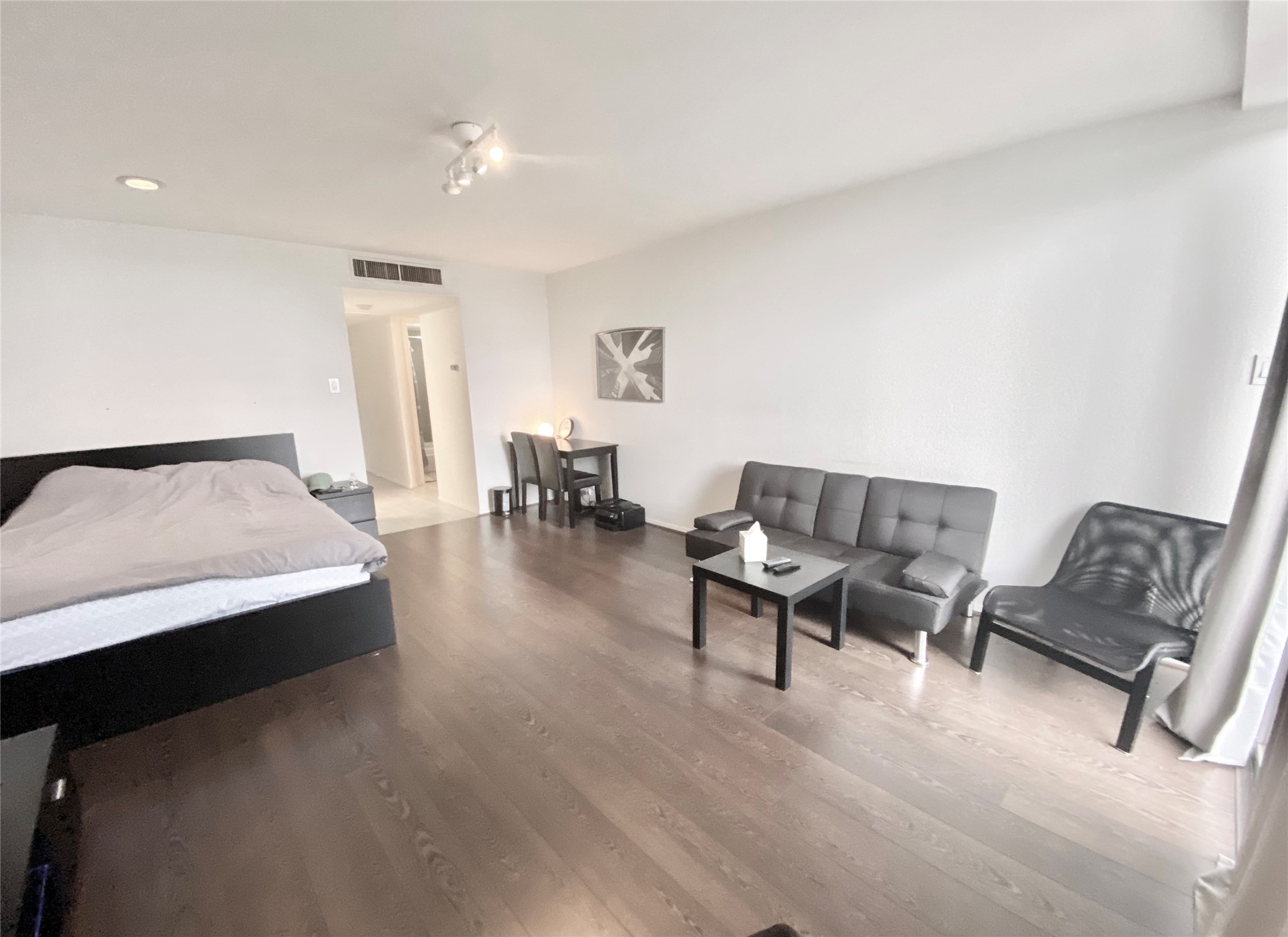 2016 Main Street, Unit 1116 Houston, TX 77002 - Photo 2 of 23 a living room with furniture and a table