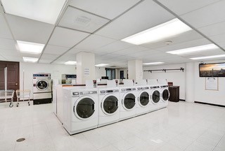 2016 Main Street, Unit 1116 Houston, TX 77002 - Photo 21 of 23 a utility room with stainless steel appliances wooden cabinet and a fireplace