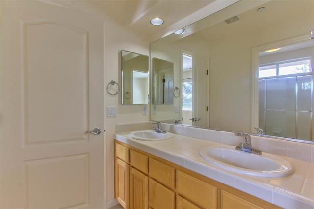 27860 Crowne Point Drive Salinas, CA 93908 - Photo 26 of 50 a bathroom with a granite countertop sink and a mirror
