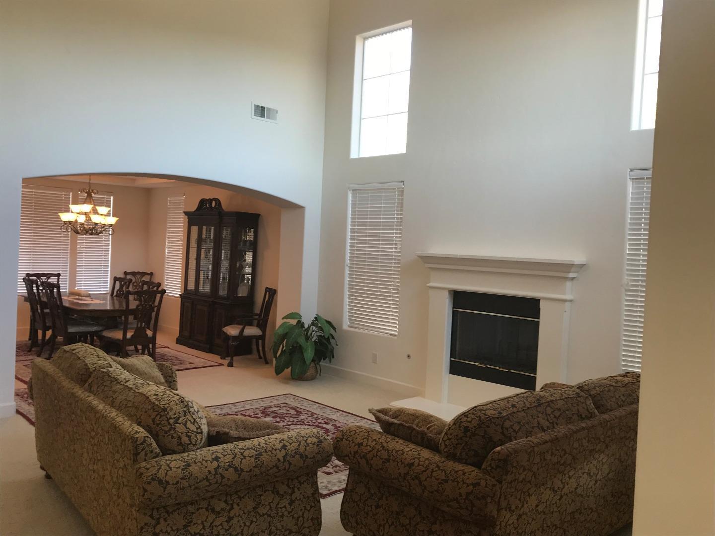 27860 Crowne Point Drive Salinas, CA 93908 - Photo 5 of 50 a living room with furniture a fireplace and a potted plant