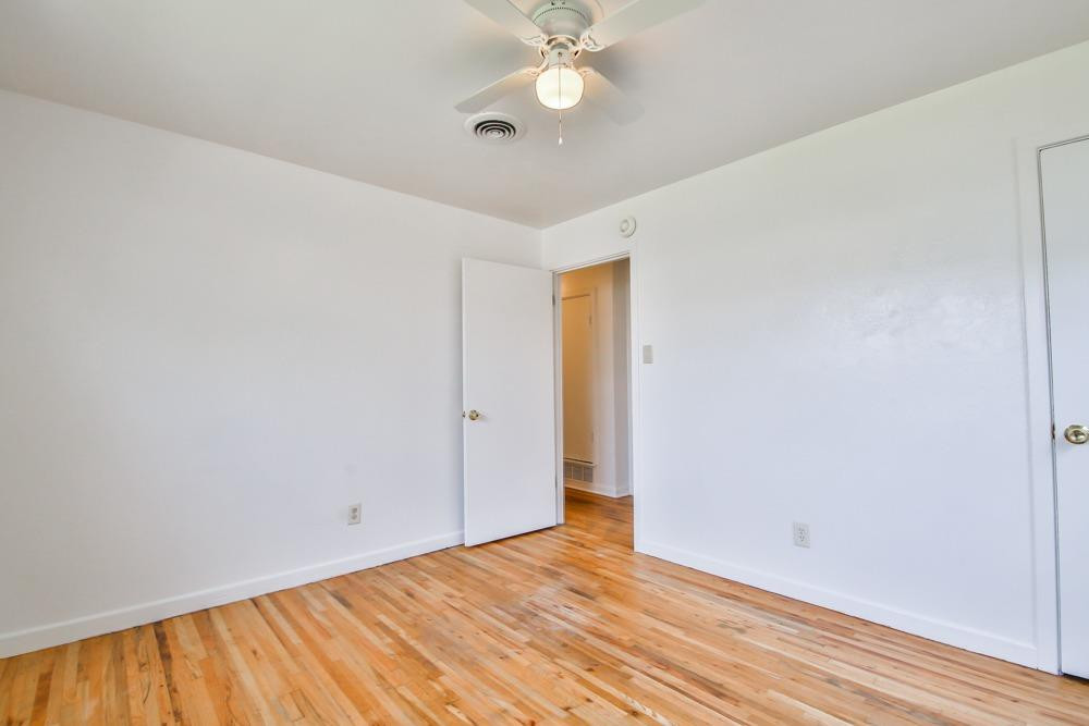 4418 33rd Street Lubbock, TX 79410 - Photo 12 of 21 wooden floor in an empty room
