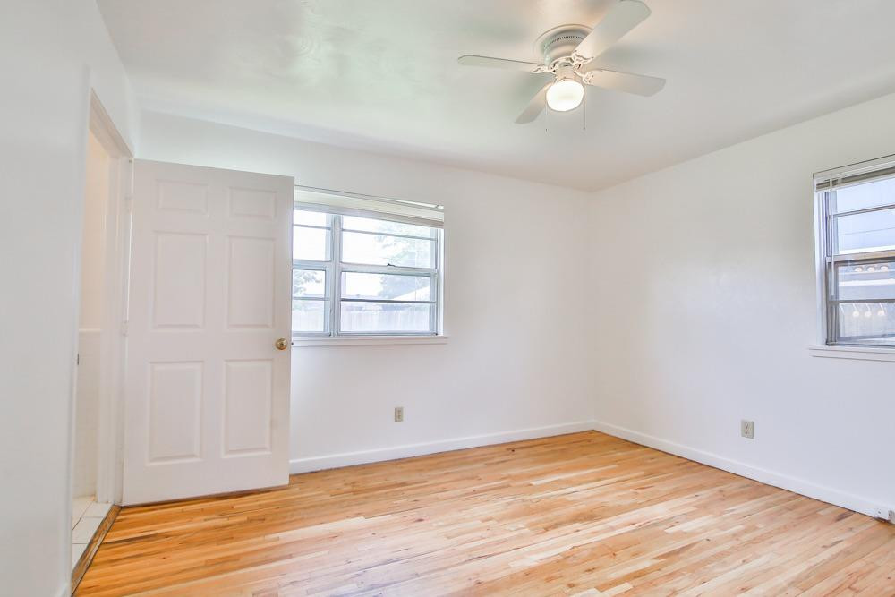 4418 33rd Street Lubbock, TX 79410 - Photo 13 of 21 wooden floor in an empty room with a window