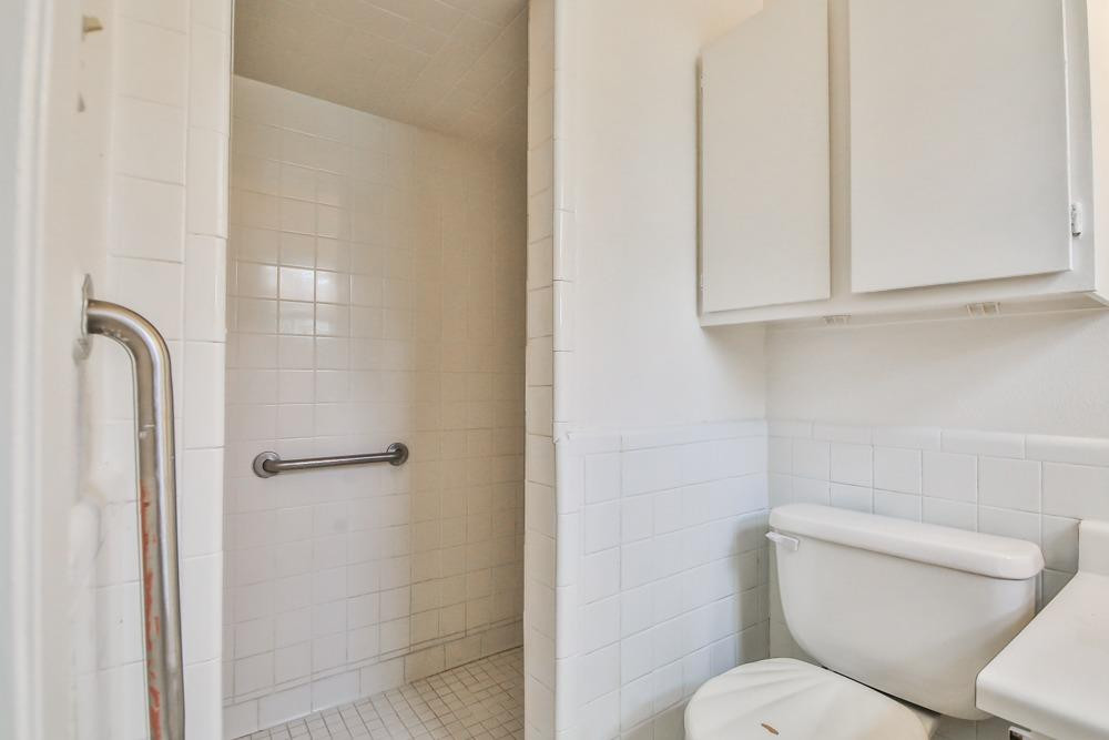 4418 33rd Street Lubbock, TX 79410 - Photo 16 of 21 a white toilet sitting next to a bathroom sink