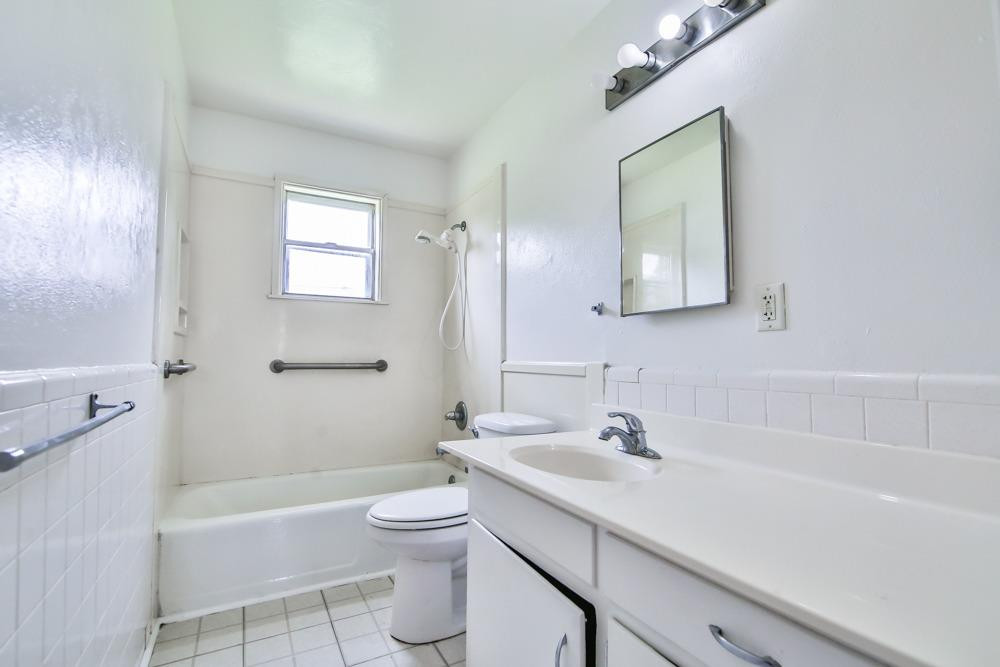 4418 33rd Street Lubbock, TX 79410 - Photo 17 of 21 a bathroom with a sink a toilet and shower