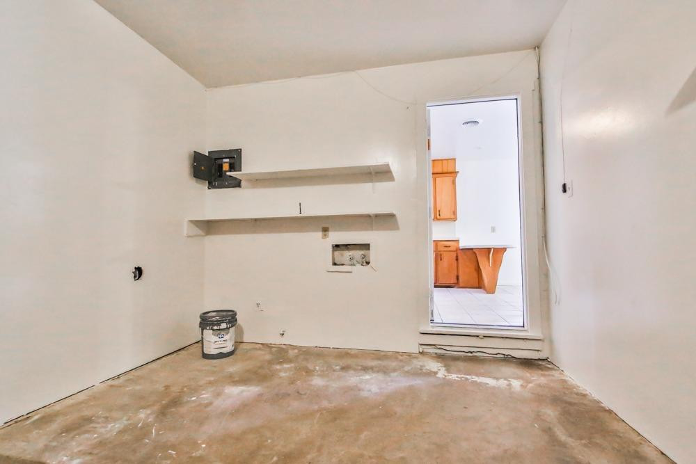 4418 33rd Street Lubbock, TX 79410 - Photo 19 of 21 a view of a storage & utility room with two washing machine
