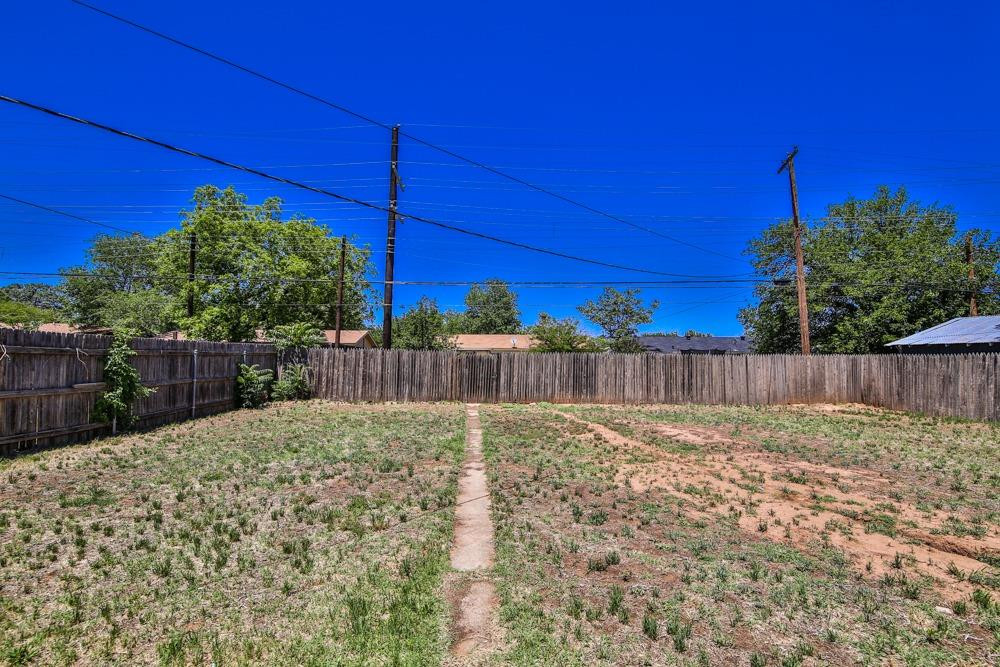 4418 33rd Street Lubbock, TX 79410 - Photo 20 of 21 a view of a backyard of the house with wooden fence
