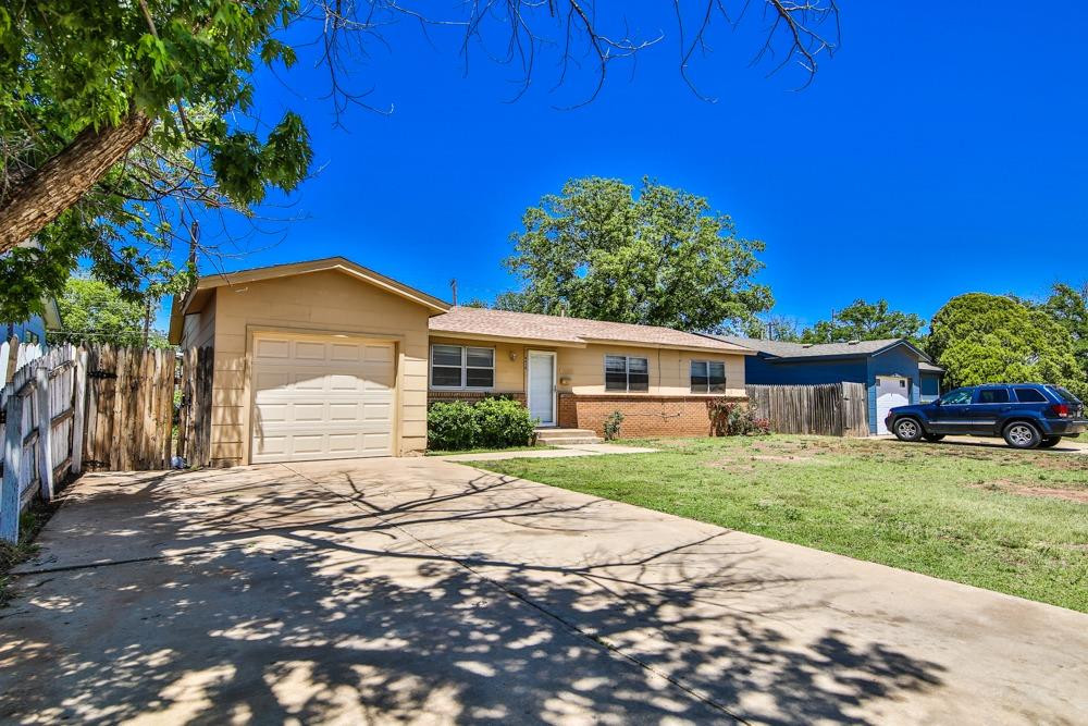4418 33rd Street Lubbock, TX 79410 - Photo 2 of 21 a front view of a house with a garden