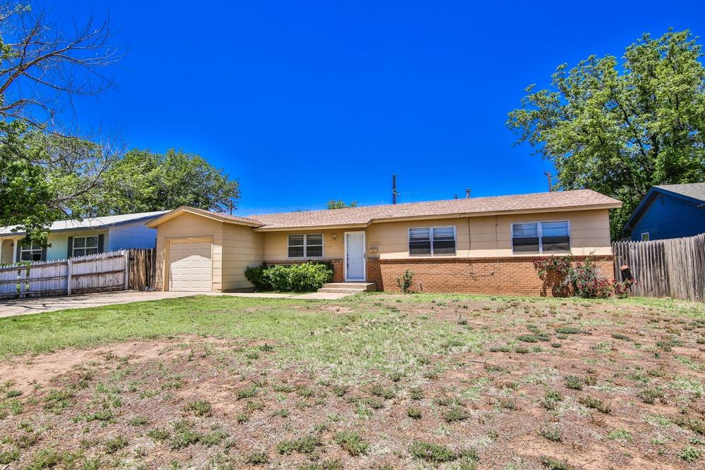 4418 33rd Street Lubbock, TX 79410 - Photo 3 of 21 a front view of a house with a garden