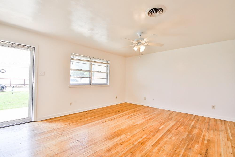 4418 33rd Street Lubbock, TX 79410 - Photo 4 of 21 an empty room with a window and ceiling fan