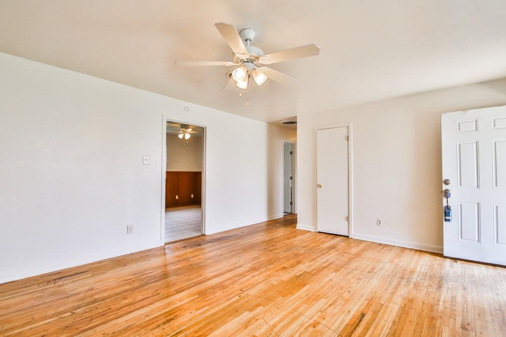 4418 33rd Street Lubbock, TX 79410 - Photo 5 of 21 a view of an empty room with wooden floor