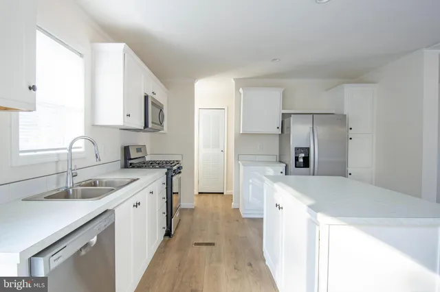 a kitchen with a sink stove and refrigerator
