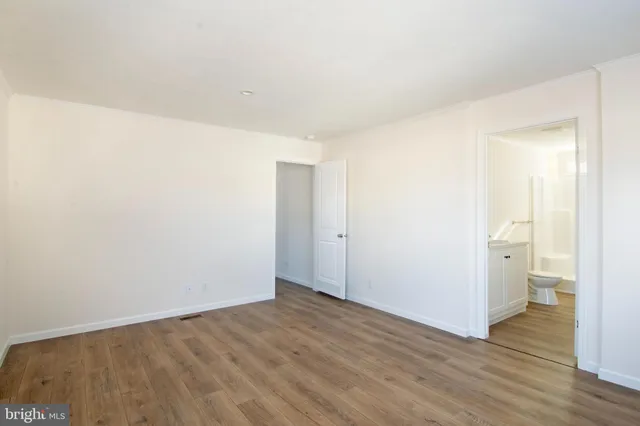 a view of a room with wooden floor