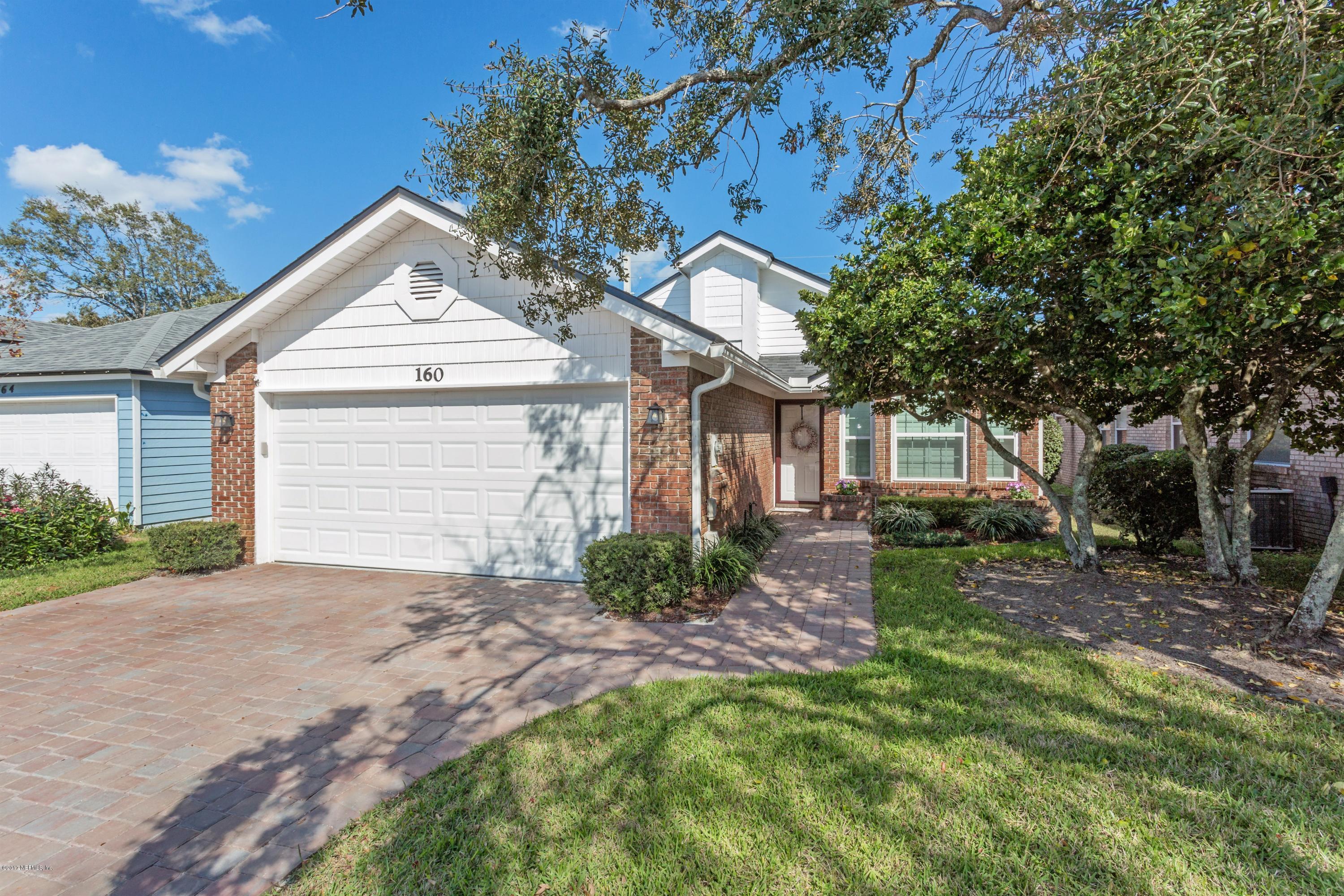 160 Patrick Mill Circle Ponte Vedra Beach, FL 32082 - Photo 1 of 23 a front view of a house with a garden and trees