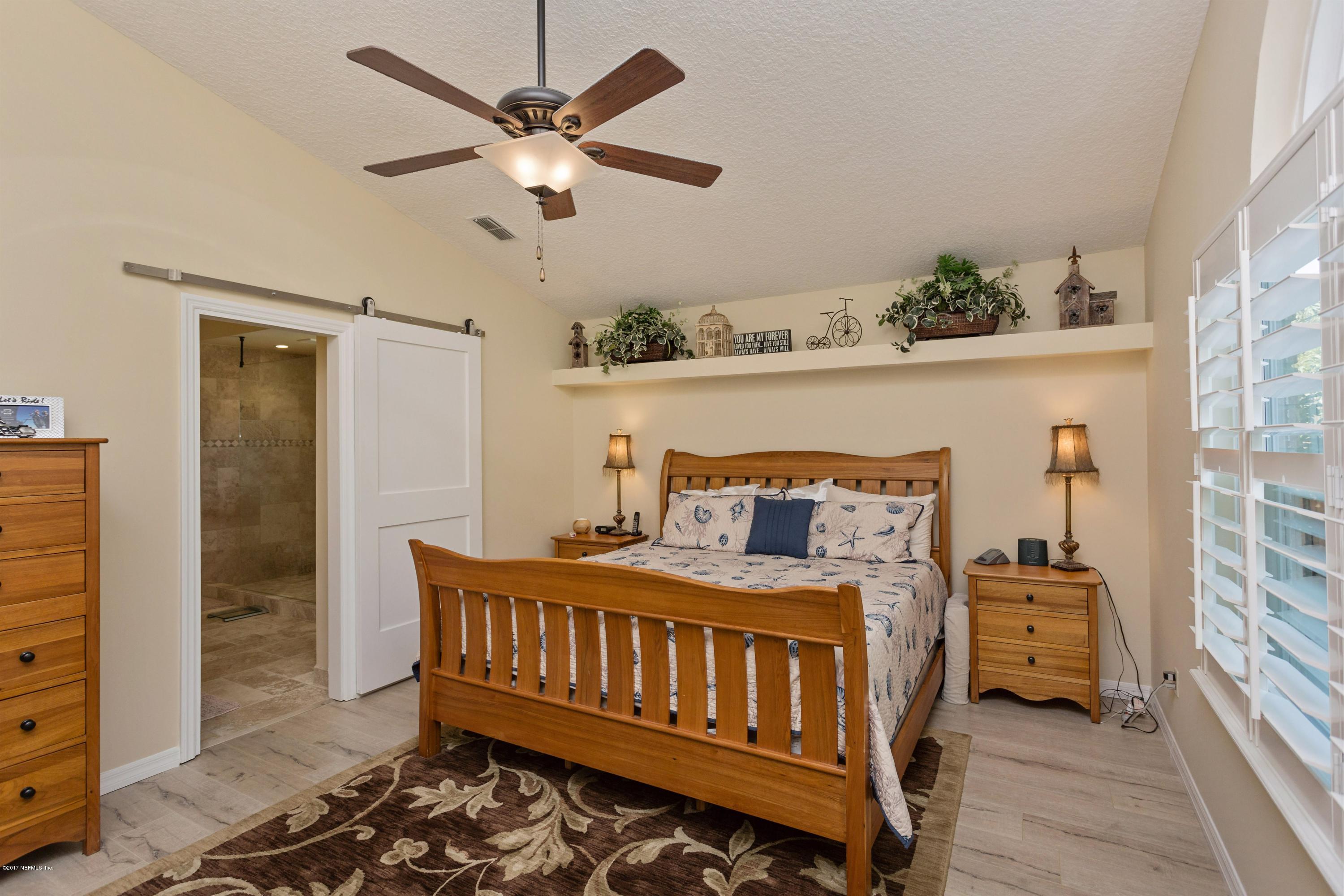160 Patrick Mill Circle Ponte Vedra Beach, FL 32082 - Photo 12 of 23 a bedroom with a bed and a chandelier