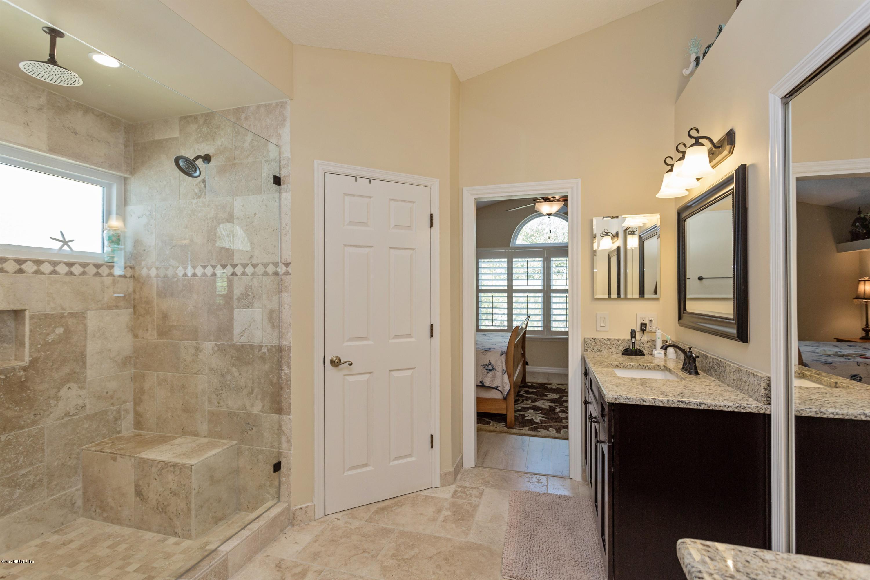 160 Patrick Mill Circle Ponte Vedra Beach, FL 32082 - Photo 14 of 23 a en suite bathroom with a double vanity sink a large mirror and shower