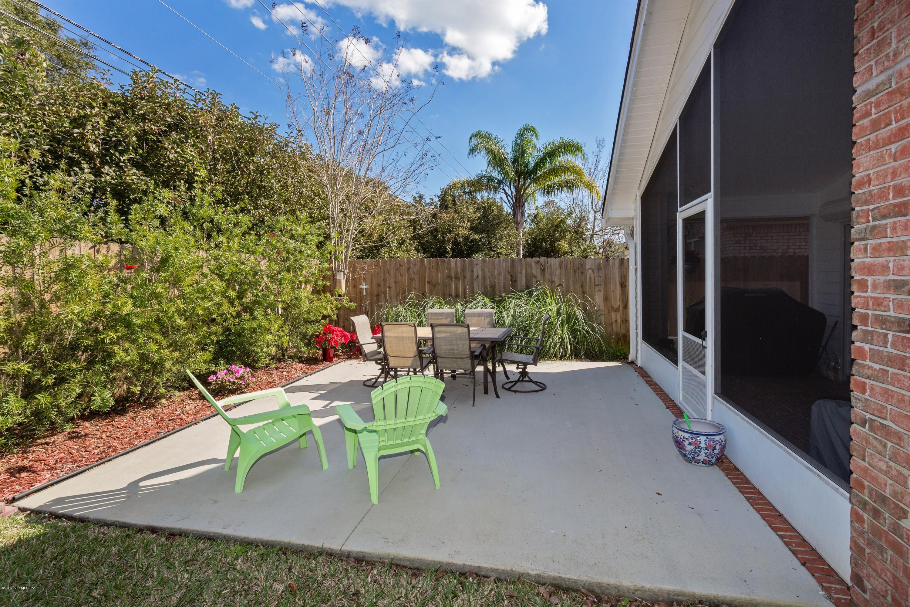160 Patrick Mill Circle Ponte Vedra Beach, FL 32082 - Photo 18 of 23 a view of a chairs and table in backyard of the house
