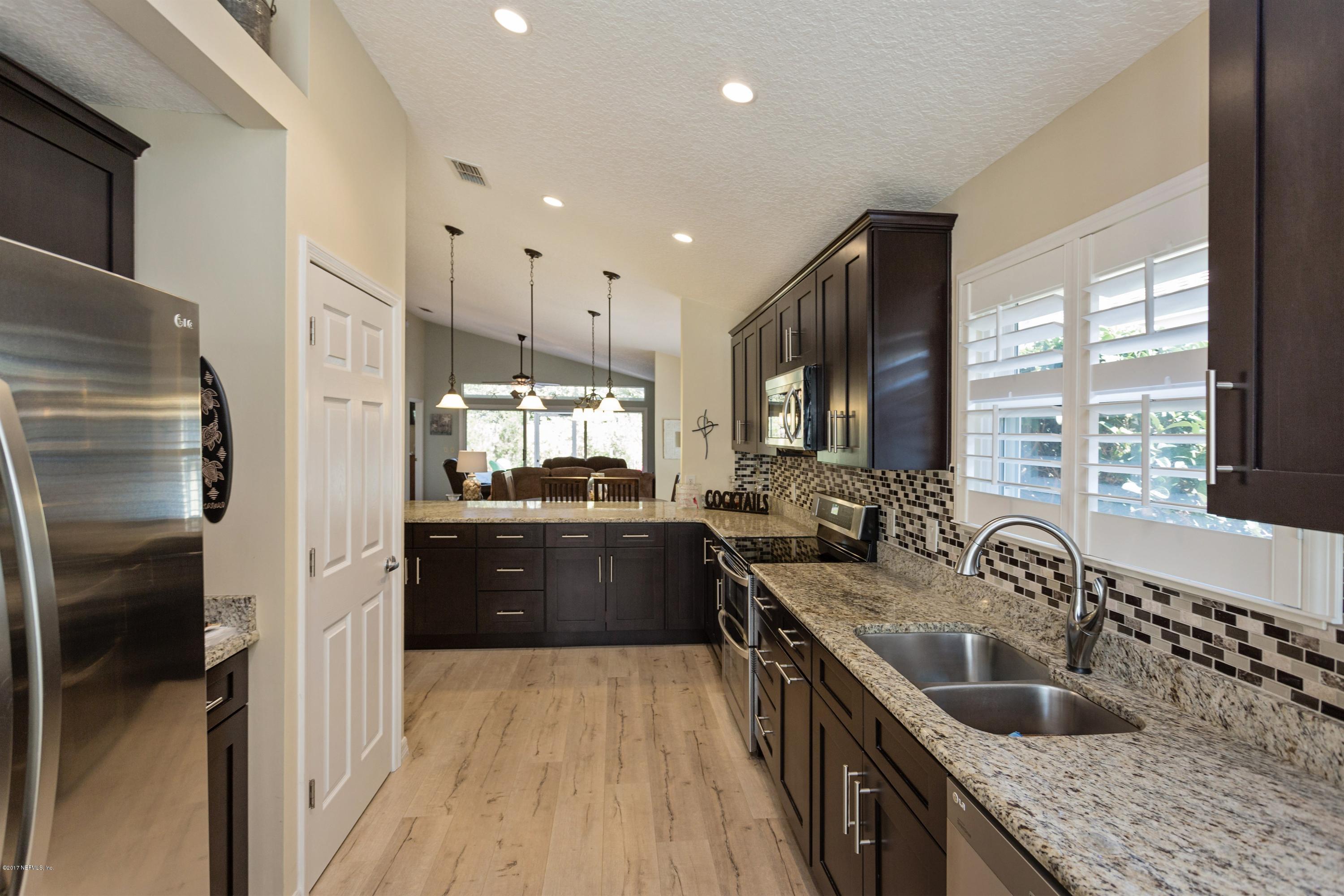 160 Patrick Mill Circle Ponte Vedra Beach, FL 32082 - Photo 5 of 23 a kitchen with granite countertop a sink stove refrigerator and cabinets